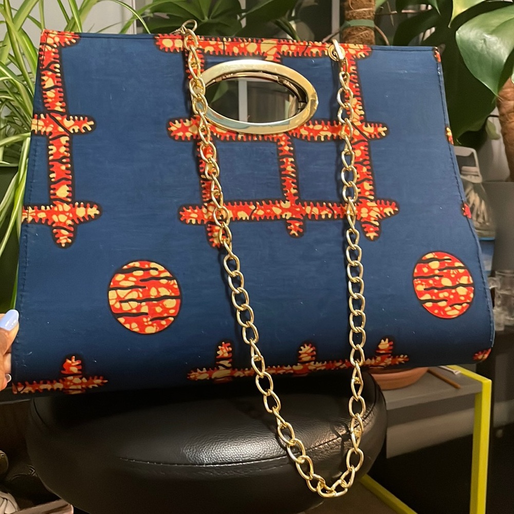 Blue, orange, and yellow bag with gold trim & chain. Button close, clean, nwot